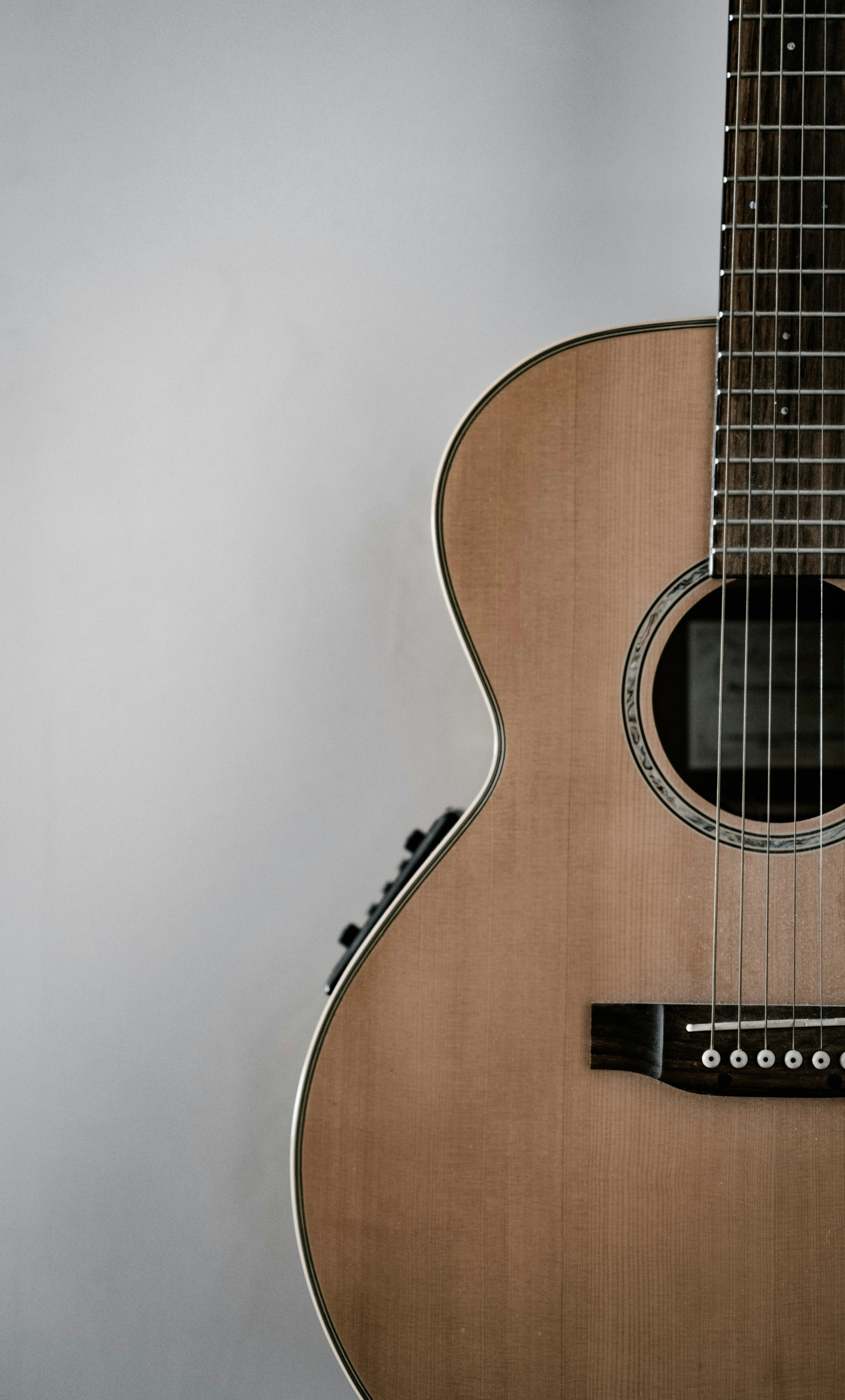 Acoustic-electric guitar with onboard preamp panel visible — the kind of stage-ready electronics every worship guitarist eventually needs