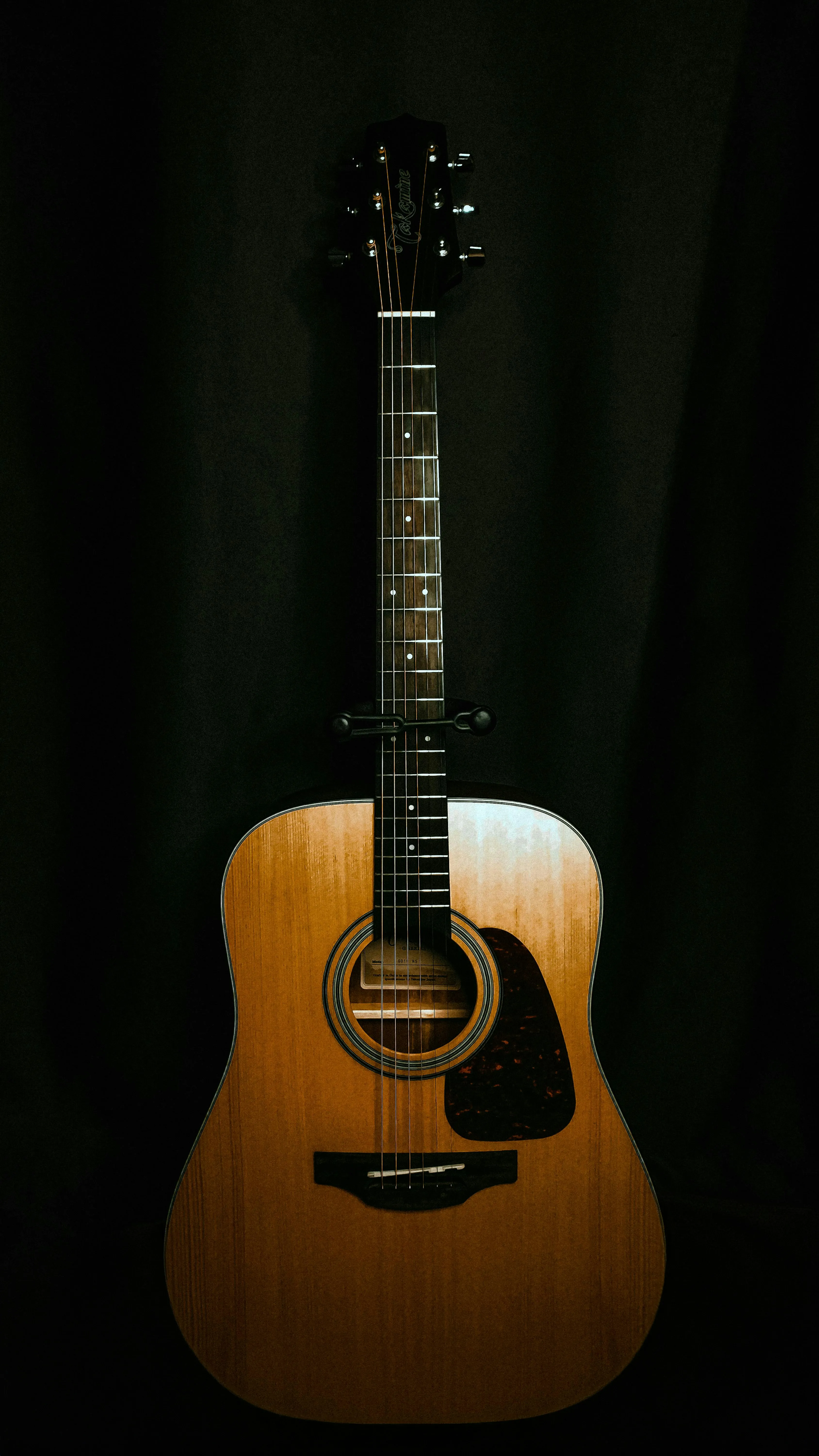 Acoustic guitar resting in warm light — the kind of instrument that earns its place on a worship stage every Sunday
