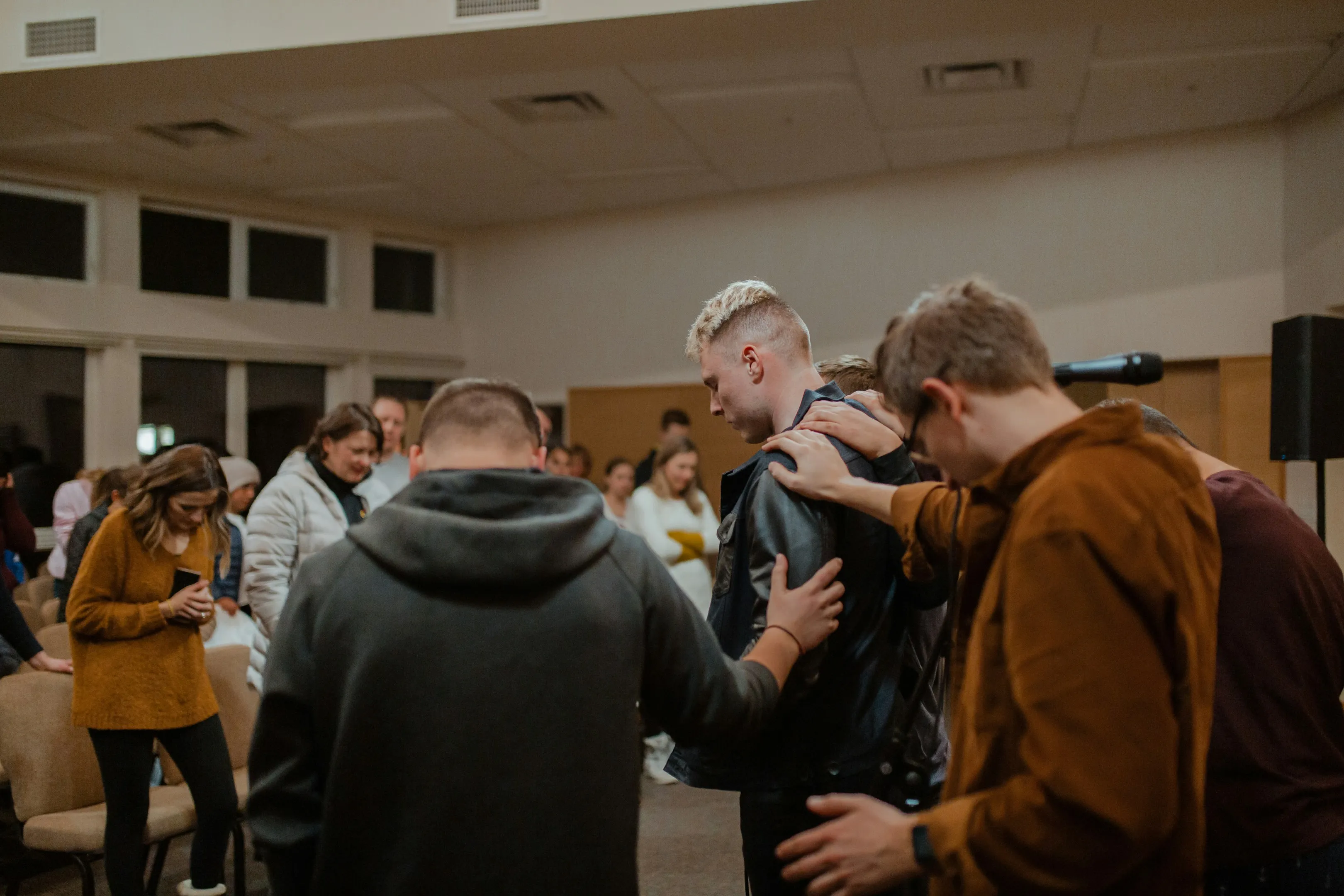Worship team gathered in prayer before a Sunday service