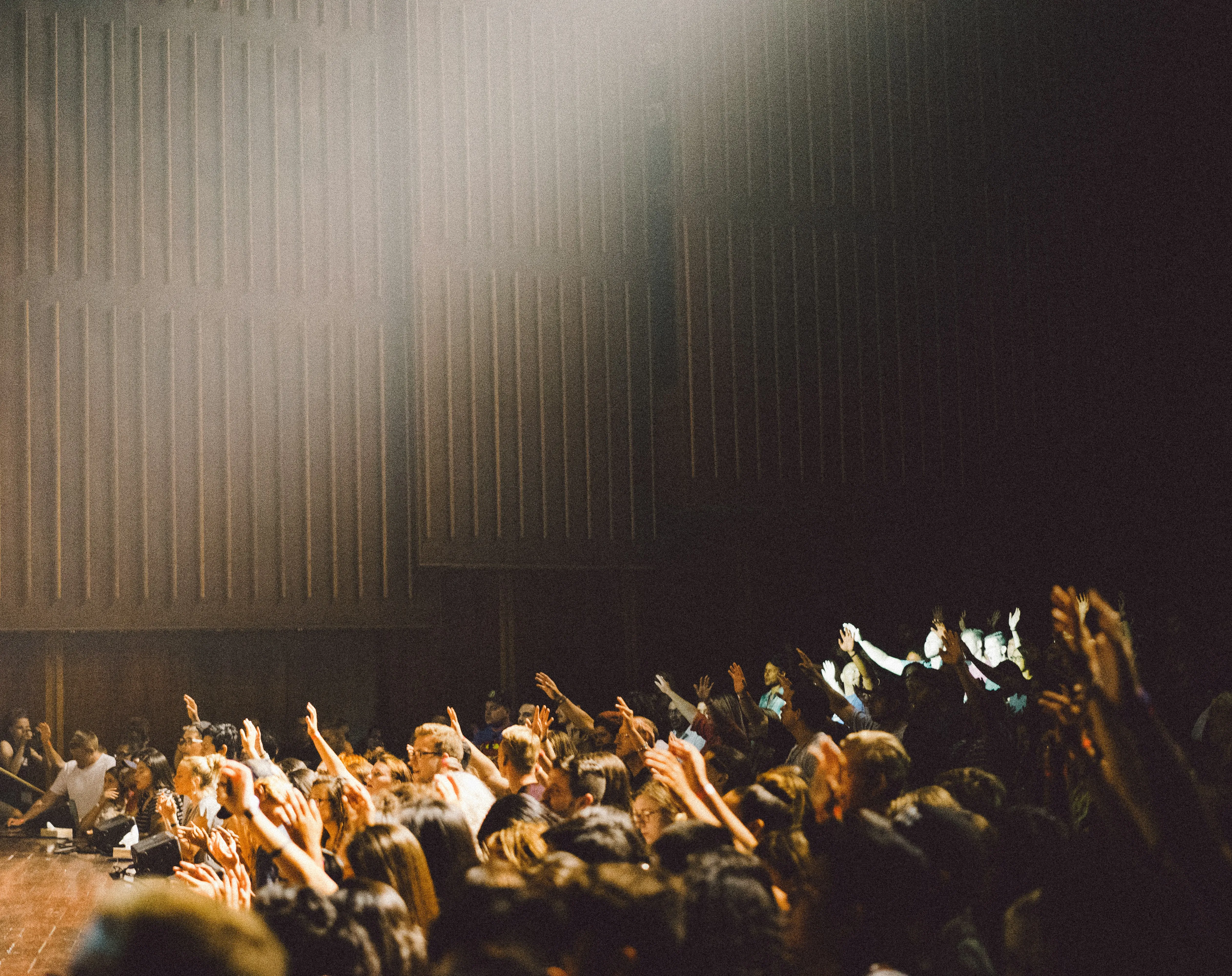 Worship leader on stage guiding the congregation through Sunday service