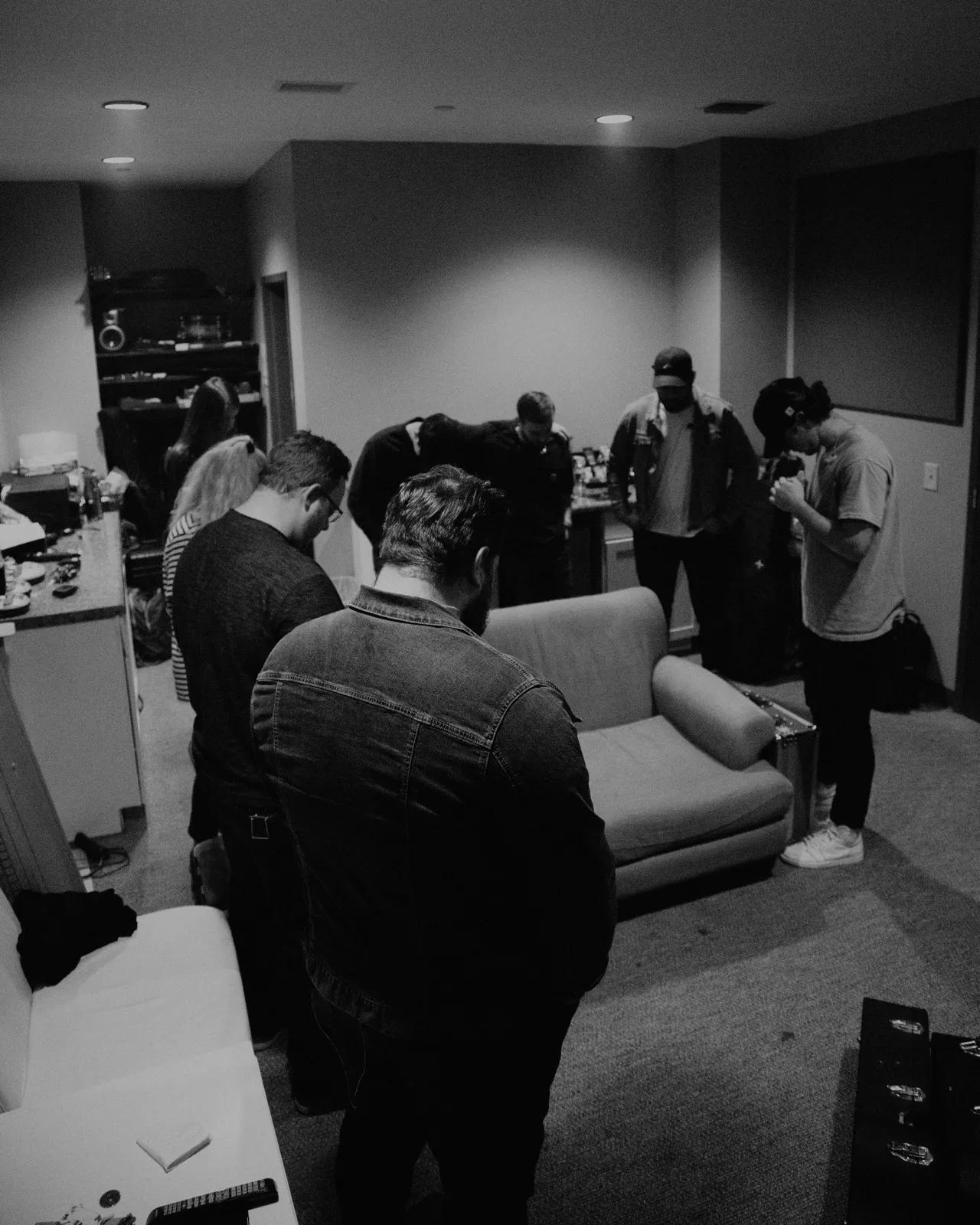 Worship team gathered in prayer before leading the congregation